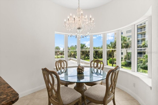 2 Oceans W Blvd Unit 206, Daytona Beach Shores, FL 32118 - dining room with light tile patterned floors, a chandelier, and a high ceiling