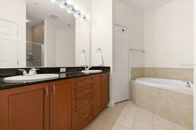 2 Oceans W Blvd Unit 206, Daytona Beach Shores, FL 32118 - full bath featuring double vanity, tile patterned flooring, a stall shower, and a garden tub