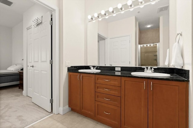 2 Oceans W Blvd Unit 206, Daytona Beach Shores, FL 32118 - bathroom featuring a shower stall, double vanity, tile patterned flooring, and ensuite bathroom