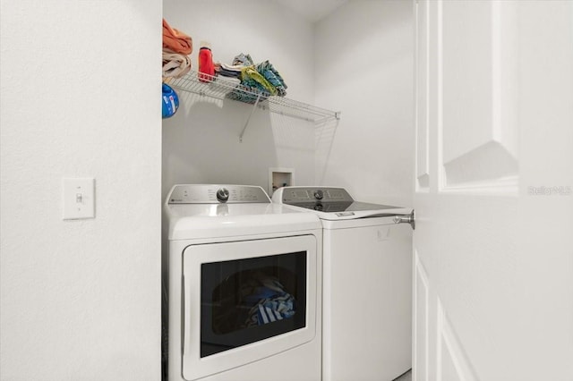 2 Oceans W Blvd Unit 206, Daytona Beach Shores, FL 32118 - laundry area featuring washing machine and clothes dryer