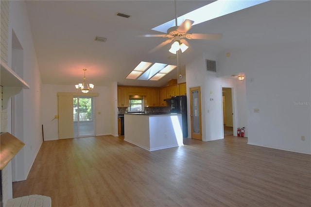2548 Crestwood Ave, New Smyrna Beach, FL 32168 - kitchen featuring a chandelier, open floor plan, ceiling fan, light wood-type flooring, and decorative backsplash