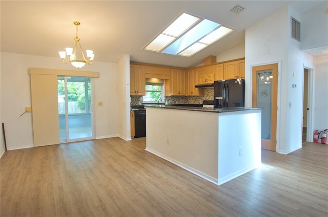 2548 Crestwood Ave, New Smyrna Beach, FL 32168 - kitchen featuring black appliances, plenty of natural light, light wood-style floors, and lofted ceiling