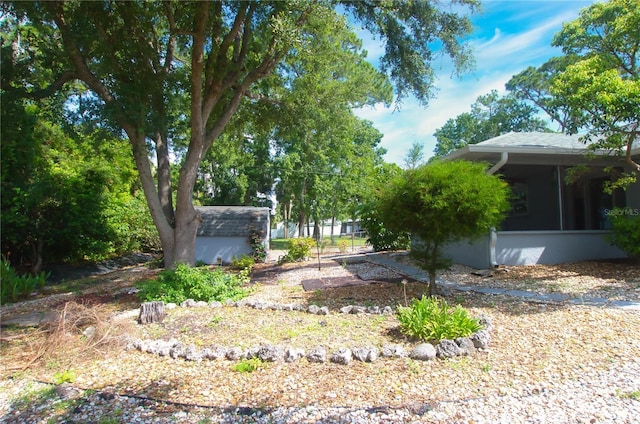 2548 Crestwood Ave, New Smyrna Beach, FL 32168 - view of yard featuring a sunroom and an outdoor structure