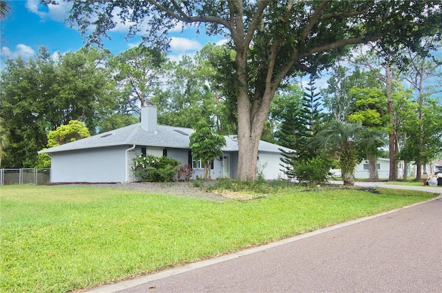 2548 Crestwood Ave, New Smyrna Beach, FL 32168 - view of front of house with a chimney, a shingled roof, and a garage