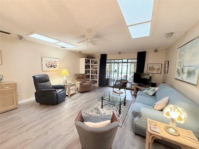 51 Fore Dr, New Smyrna Beach, FL 32168 - living room with a ceiling fan, wood finished floors, and a textured ceiling