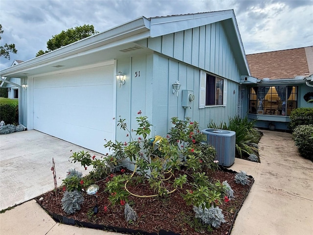 51 Fore Dr, New Smyrna Beach, FL 32168 - view of property exterior featuring board and batten siding, driveway, and a garage