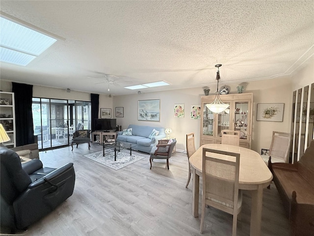 51 Fore Dr, New Smyrna Beach, FL 32168 - dining area featuring a skylight, a textured ceiling, wood finished floors, and a ceiling fan