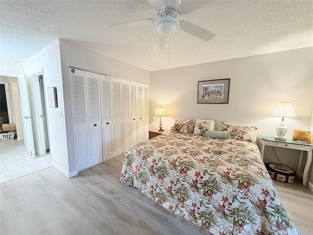 51 Fore Dr, New Smyrna Beach, FL 32168 - bedroom with light wood-style flooring, a textured ceiling, ceiling fan, and a closet