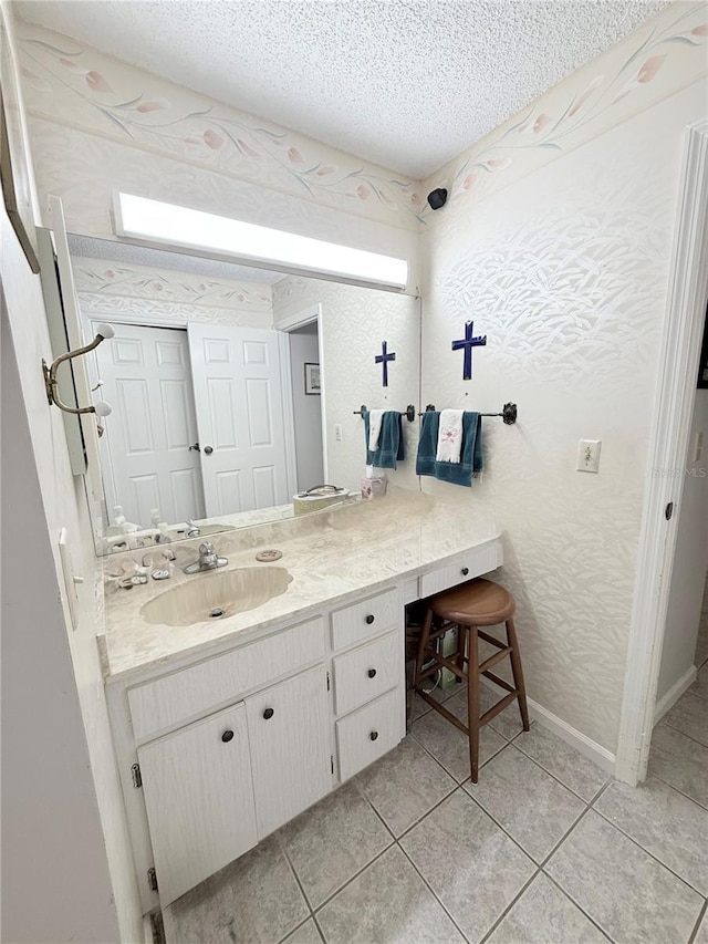 51 Fore Dr, New Smyrna Beach, FL 32168 - bathroom with vanity, a textured ceiling, and tile patterned flooring