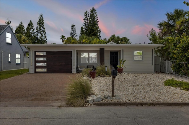 206 Kirkland Rd, New Smyrna Beach, FL 32169 - view of front facade with decorative driveway and an attached garage