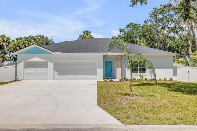 2324 Orange Tree Dr, Edgewater, FL 32141 - view of front of house with an attached garage, concrete driveway, stucco siding, and a shingled roof