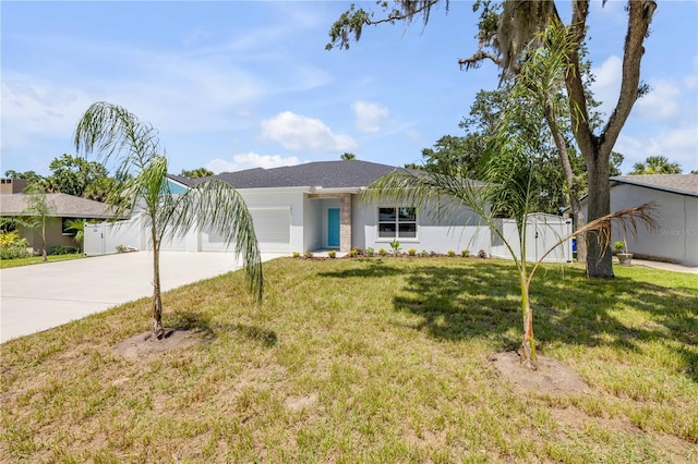 2324 Orange Tree Dr, Edgewater, FL 32141 - view of front of property featuring concrete driveway, an attached garage, a gate, and stucco siding