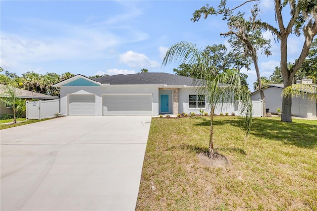 2324 Orange Tree Dr, Edgewater, FL 32141 - ranch-style home with a garage, concrete driveway, a gate, and stucco siding