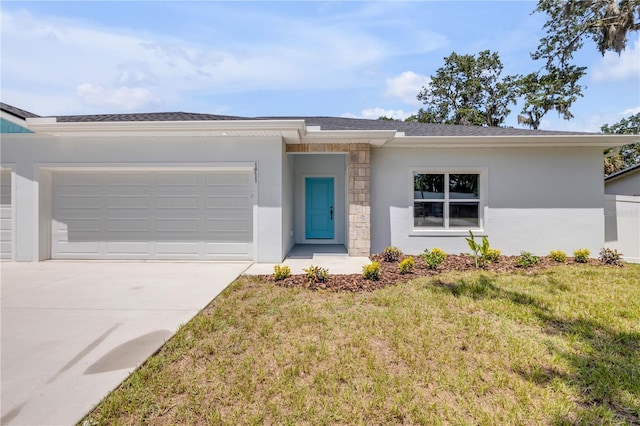 2324 Orange Tree Dr, Edgewater, FL 32141 - view of front facade with concrete driveway, an attached garage, a front lawn, stucco siding, and stone siding