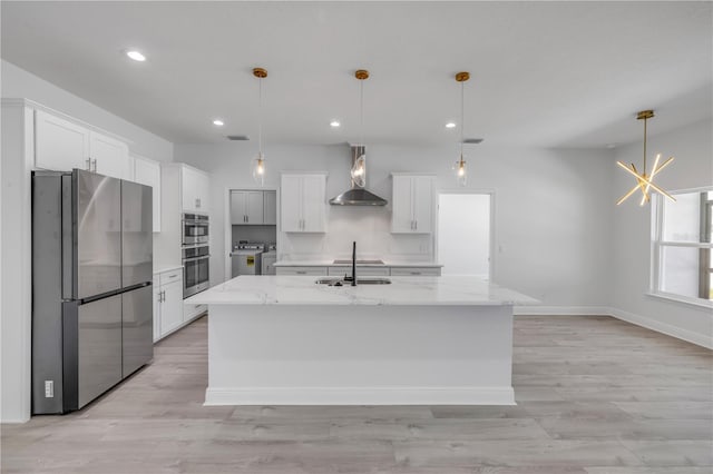 2324 Orange Tree Dr, Edgewater, FL 32141 - kitchen featuring appliances with stainless steel finishes, wall chimney exhaust hood, washer and dryer, recessed lighting, and white cabinets
