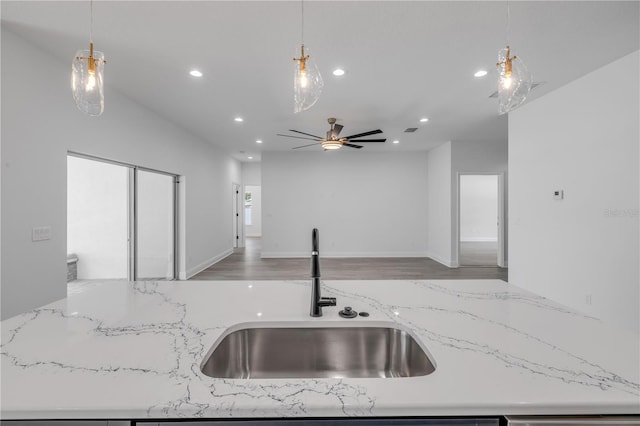 2324 Orange Tree Dr, Edgewater, FL 32141 - kitchen with open floor plan, recessed lighting, ceiling fan, light stone counters, and hanging light fixtures