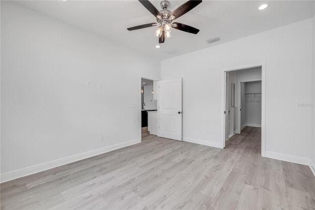 2324 Orange Tree Dr, Edgewater, FL 32141 - unfurnished bedroom with light wood-type flooring, a spacious closet, recessed lighting, a ceiling fan, and a closet