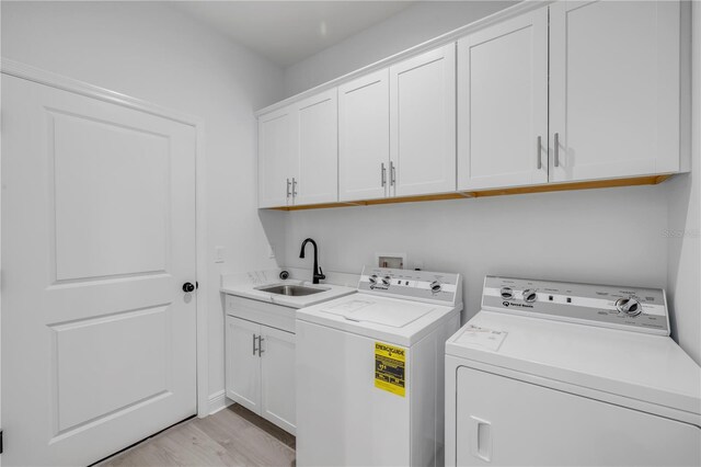 2324 Orange Tree Dr, Edgewater, FL 32141 - laundry room with independent washer and dryer, cabinet space, and light wood finished floors