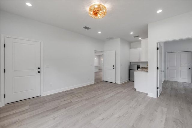 2324 Orange Tree Dr, Edgewater, FL 32141 - unfurnished living room with light wood-style flooring and recessed lighting