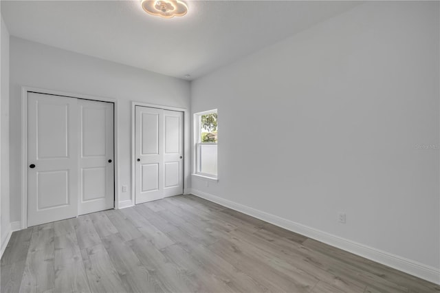 2324 Orange Tree Dr, Edgewater, FL 32141 - unfurnished bedroom with wood finished floors and multiple closets