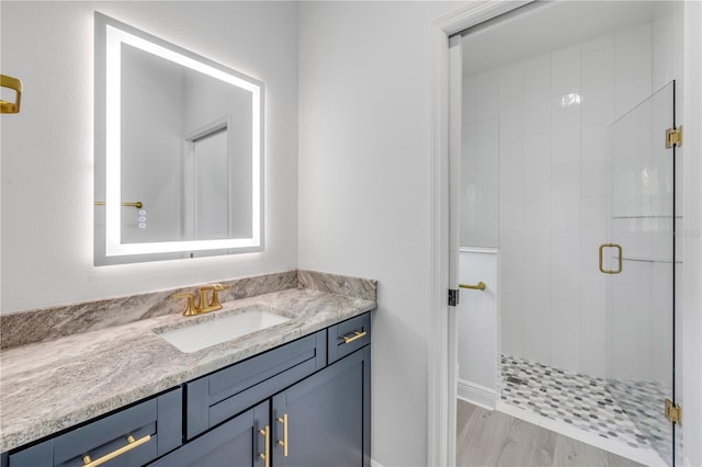 2324 Orange Tree Dr, Edgewater, FL 32141 - bathroom featuring a stall shower, vanity, and wood finished floors