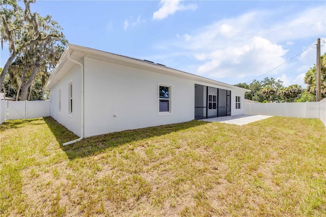 2324 Orange Tree Dr, Edgewater, FL 32141 - rear view of property with a fenced backyard, stucco siding, and a patio
