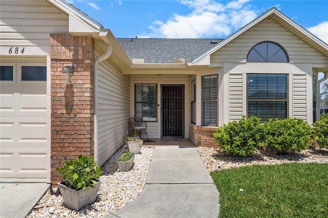 684 Rochester Ct, New Smyrna Beach, FL 32168 - property entrance featuring roof with shingles and an attached garage