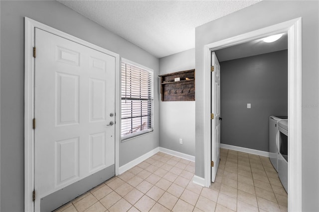 684 Rochester Ct, New Smyrna Beach, FL 32168 - foyer entrance with washing machine and clothes dryer, a textured ceiling, and light tile patterned flooring