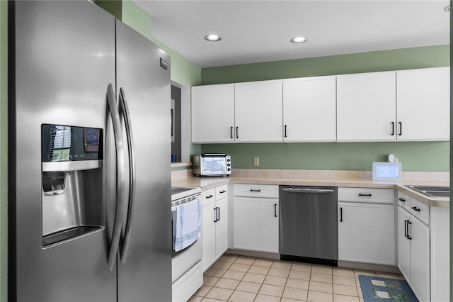 684 Rochester Ct, New Smyrna Beach, FL 32168 - kitchen featuring stainless steel appliances, light countertops, white cabinetry, recessed lighting, and light tile patterned floors