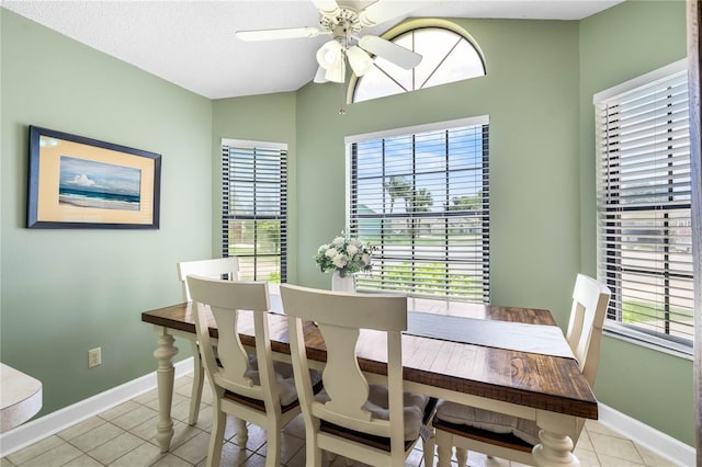 684 Rochester Ct, New Smyrna Beach, FL 32168 - dining room with light tile patterned flooring, a ceiling fan, vaulted ceiling, and a textured ceiling