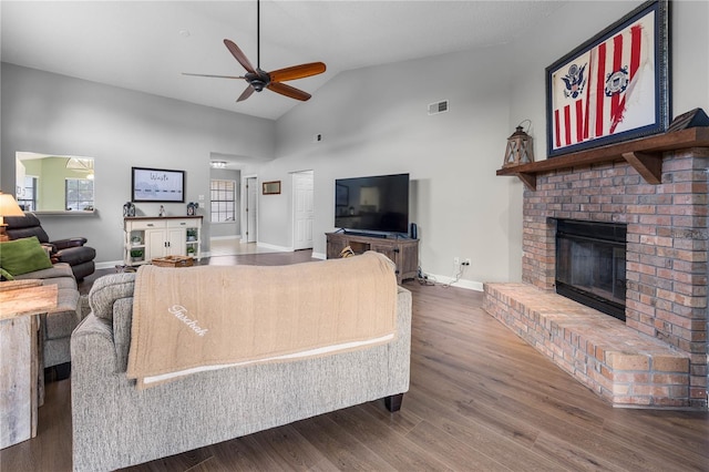 684 Rochester Ct, New Smyrna Beach, FL 32168 - living room featuring a ceiling fan, a fireplace, wood finished floors, and high vaulted ceiling