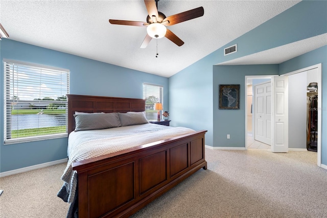 684 Rochester Ct, New Smyrna Beach, FL 32168 - bedroom featuring light carpet, a textured ceiling, vaulted ceiling, and ceiling fan