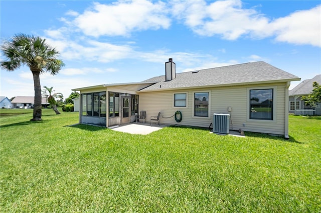 684 Rochester Ct, New Smyrna Beach, FL 32168 - back of house with a sunroom, a patio area, a yard, and a chimney