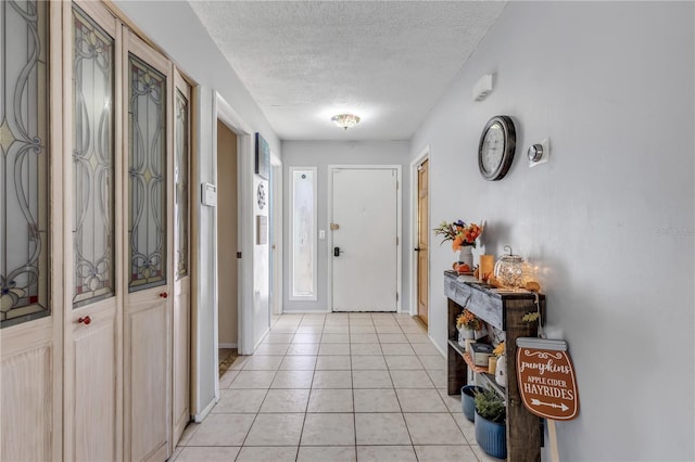 2715 Pine Tree Dr, Edgewater, FL 32141 - foyer with a textured ceiling and light tile patterned flooring