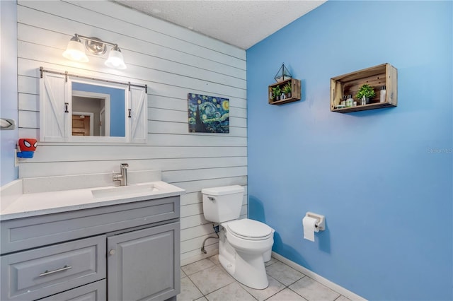 2715 Pine Tree Dr, Edgewater, FL 32141 - bathroom with wooden walls, vanity, tile patterned flooring, and a textured ceiling