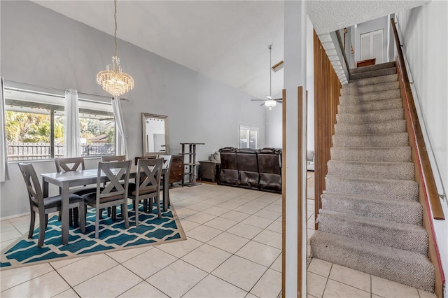 2715 Pine Tree Dr, Edgewater, FL 32141 - dining area with high vaulted ceiling, stairway, light tile patterned floors, a chandelier, and a ceiling fan