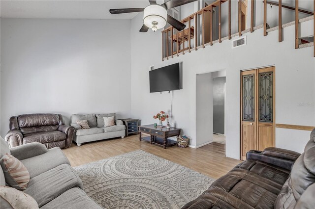 2715 Pine Tree Dr, Edgewater, FL 32141 - living room featuring ceiling fan, a towering ceiling, and wood finished floors
