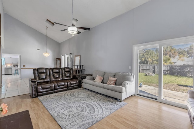 2715 Pine Tree Dr, Edgewater, FL 32141 - living room featuring high vaulted ceiling, a ceiling fan, and light wood-style flooring