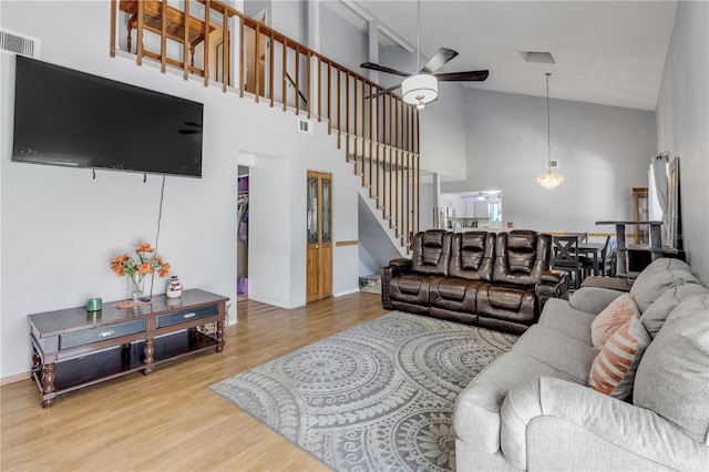 2715 Pine Tree Dr, Edgewater, FL 32141 - living area with a ceiling fan, stairs, high vaulted ceiling, and light wood finished floors