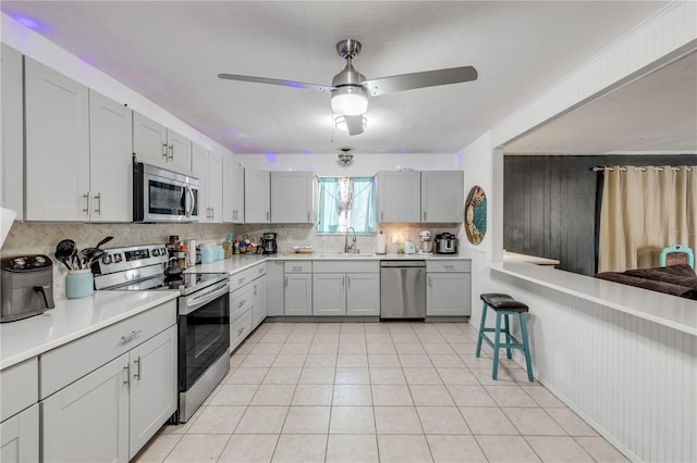 2715 Pine Tree Dr, Edgewater, FL 32141 - kitchen with stainless steel appliances, tasteful backsplash, ceiling fan, and light countertops