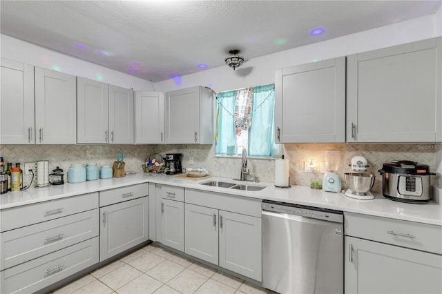 2715 Pine Tree Dr, Edgewater, FL 32141 - kitchen featuring stainless steel dishwasher, gray cabinets, tasteful backsplash, light tile patterned floors, and a textured ceiling