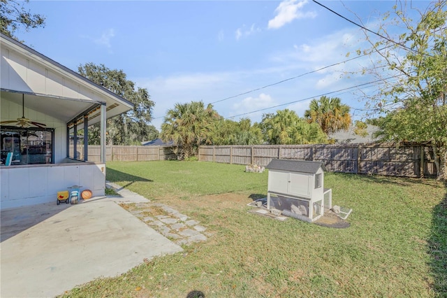2715 Pine Tree Dr, Edgewater, FL 32141 - fenced backyard with a ceiling fan, a patio, exterior structure, and an outbuilding