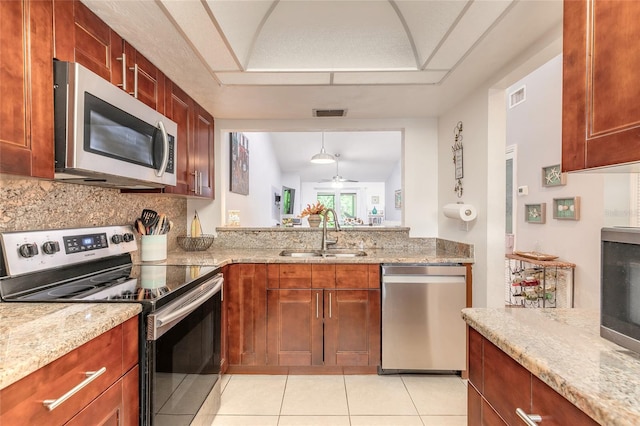 1237 Charter Oaks Cir, Daytona Beach, FL 32117 - kitchen featuring stainless steel appliances, light tile patterned floors, backsplash, ceiling fan, and light stone countertops