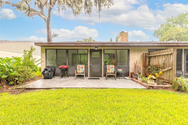 1237 Charter Oaks Cir, Daytona Beach, FL 32117 - back of house featuring a patio area, a chimney, a yard, and stucco siding
