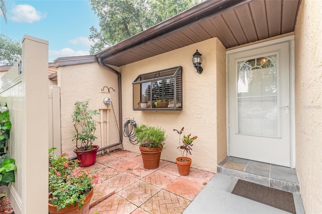 1237 Charter Oaks Cir, Daytona Beach, FL 32117 - entrance to property featuring stucco siding and a patio area