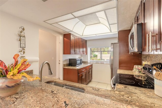 1237 Charter Oaks Cir, Daytona Beach, FL 32117 - kitchen with appliances with stainless steel finishes, light stone counters, light tile patterned flooring, and decorative backsplash