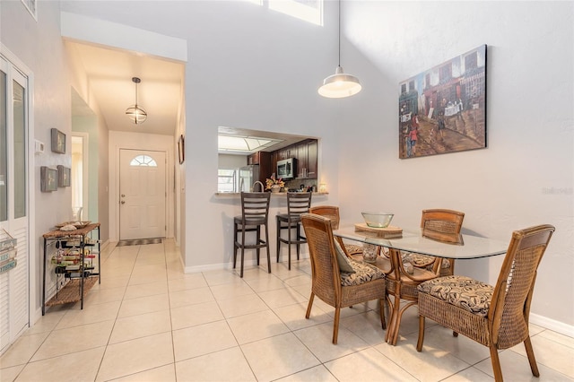 1237 Charter Oaks Cir, Daytona Beach, FL 32117 - dining space featuring a high ceiling and light tile patterned floors