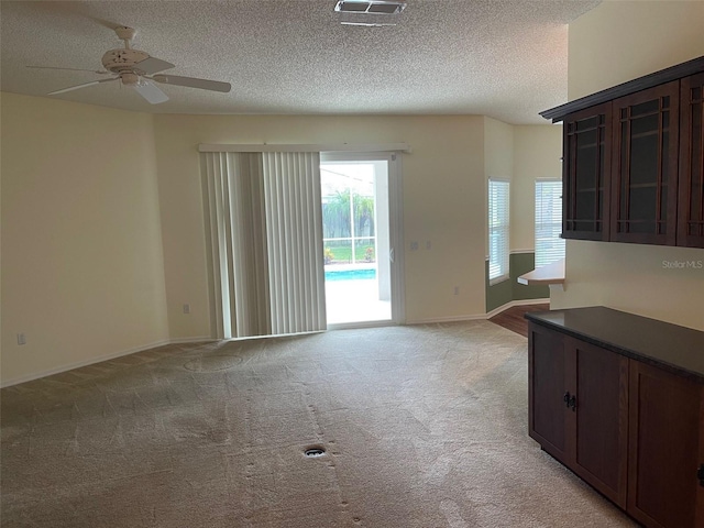 405 Central Mariners Dr, Edgewater, FL 32141 - unfurnished living room with light colored carpet, ceiling fan, and a textured ceiling