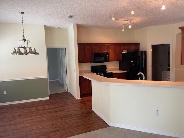 405 Central Mariners Dr, Edgewater, FL 32141 - kitchen featuring black appliances, dark wood-type flooring, light countertops, a textured ceiling, and pendant lighting