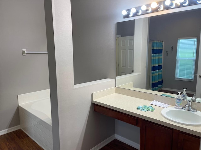 405 Central Mariners Dr, Edgewater, FL 32141 - bathroom with vanity, wood finished floors, a tub to relax in, and a shower with shower curtain